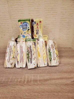 A display of packaged sandwiches and two boxes of instant noodles. - Empire Hotel (Taipei)