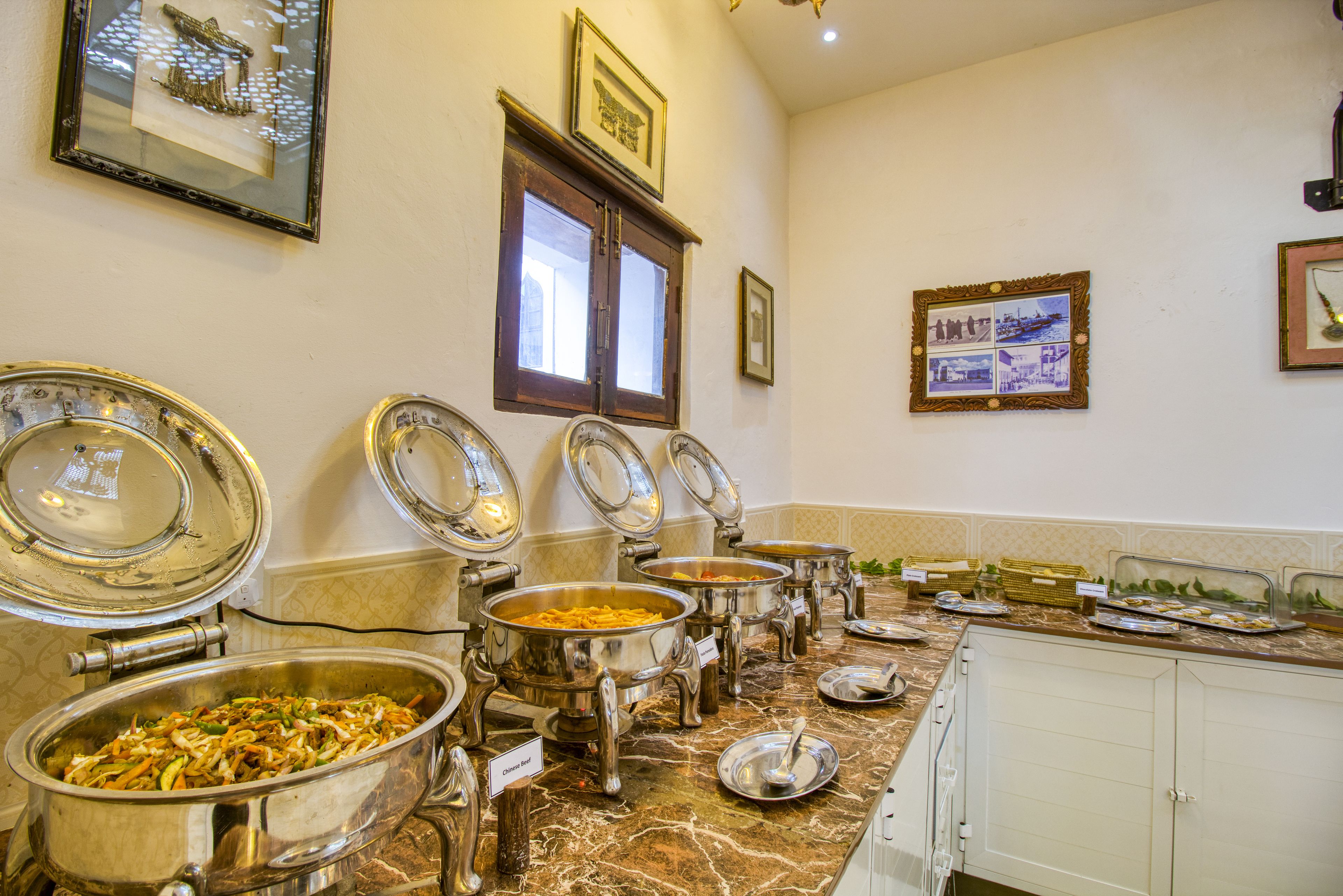 A buffet setup with multiple serving dishes and a marble countertop.