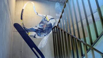 A staircase with metal railings and a wall with a graffiti-style mural.