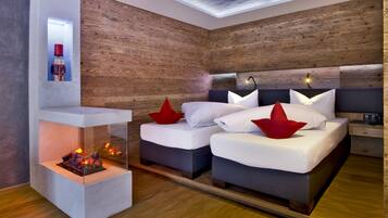 Cozy retreat with a comfortable bed, fireplace, and skylight.