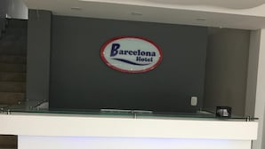 A reception desk with a sign for the Barcelona Hotel. - Barcelona Hotel (Montería)