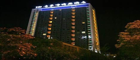 A high-rise hotel with illuminated signage at the top.