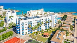 A hotel with multiple floors, balconies, and a pool area. - Tetyk Hotel  (Paralimni)