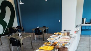 A buffet setup with various food items and seating arrangements.