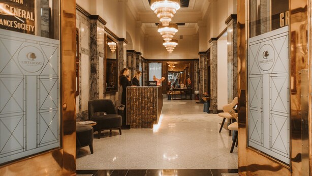 A hotel lobby with a marble floor, chandeliers, and a reception desk. - DoubleTree by Hilton Wellington (Wellington)
