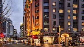 A multi-story hotel with a prominent entrance, a pedestrian area, and a street view with traffic lights. - DoubleTree by Hilton Wellington (Wellington)