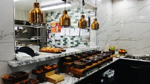 A buffet setup with various food items and a marble countertop. - DoubleTree by Hilton Wellington (Wellington)