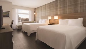 A hotel room with two beds, a desk, a chair, and a TV. - Radisson Hotel Kingswood Hotel Fredericton, NB (Hanwell)