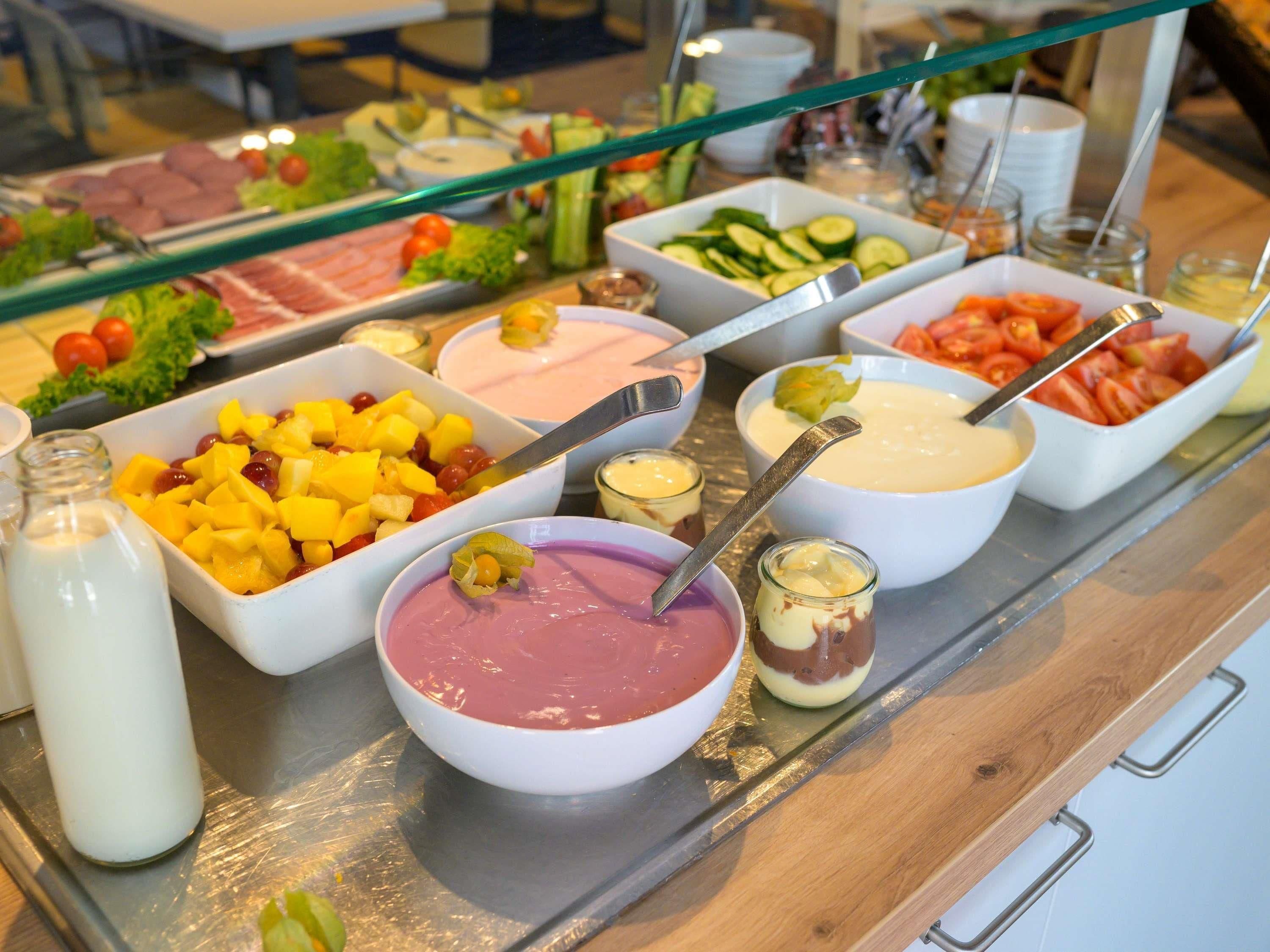 A buffet with various food items and beverages.