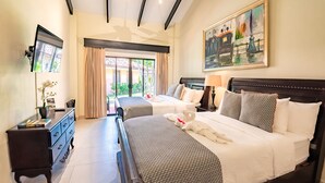 A hotel room with two beds, a TV, a dresser, and a painting.