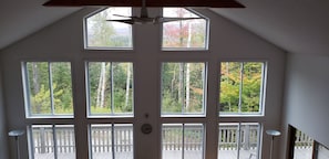 Enjoy expansive views of the forest from large windows with a symmetrical design.