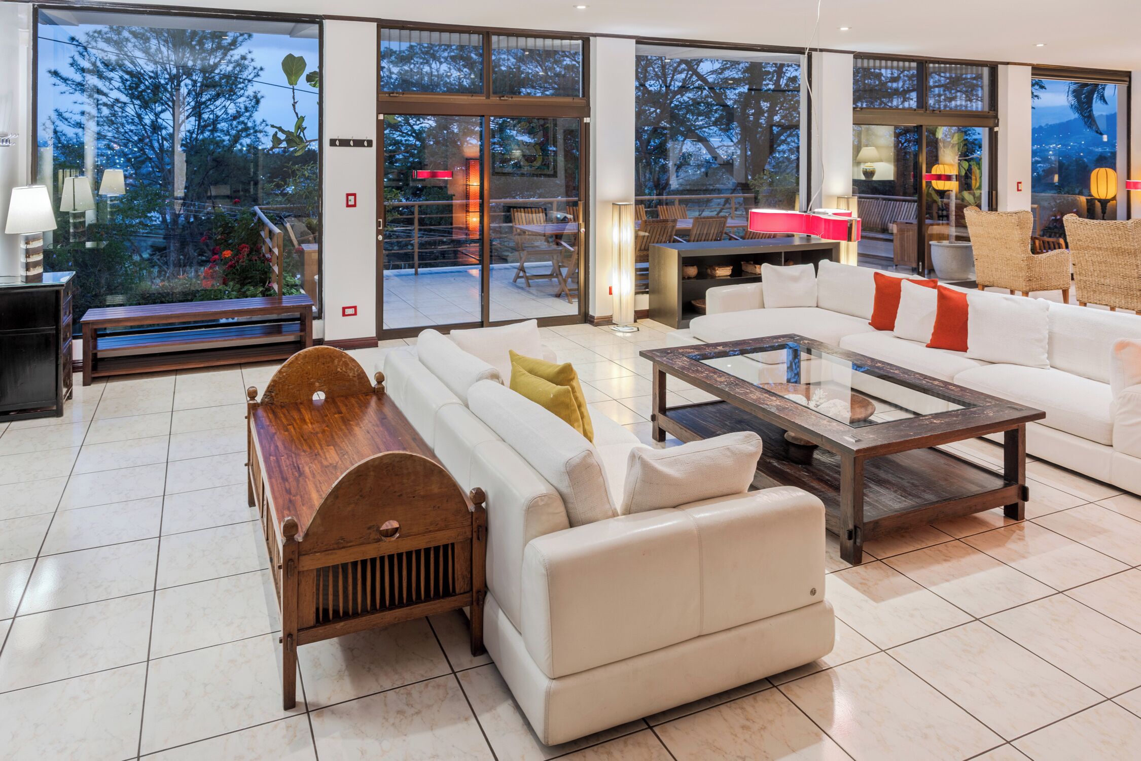 A spacious living area with a sofa, a wooden bench, and a coffee table.