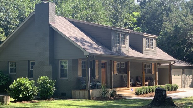 A two-story house with a front porch, a garage, and a well-maintained lawn. - Sanitized! Spacious Ranch Close To Gsp Airport, Greenville, Greer set on acres.  (Greenville)