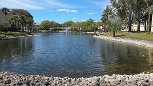 A calm lake with a fountain in the center, surrounded by trees and buildings. - 300 OFF APRIL TO NOVEMBER (Naples)