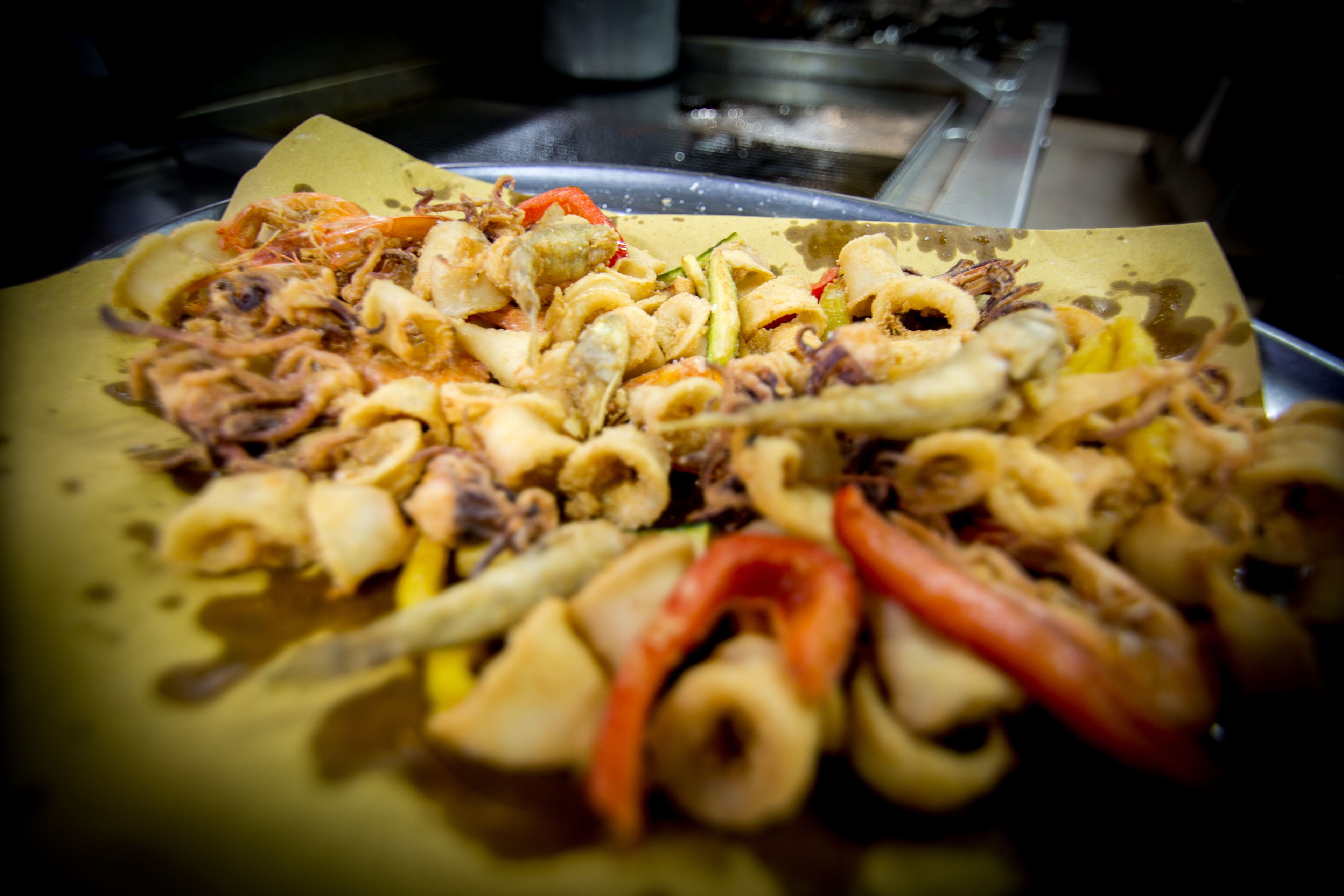 A tray of food with various ingredients including vegetables and possibly seafood.