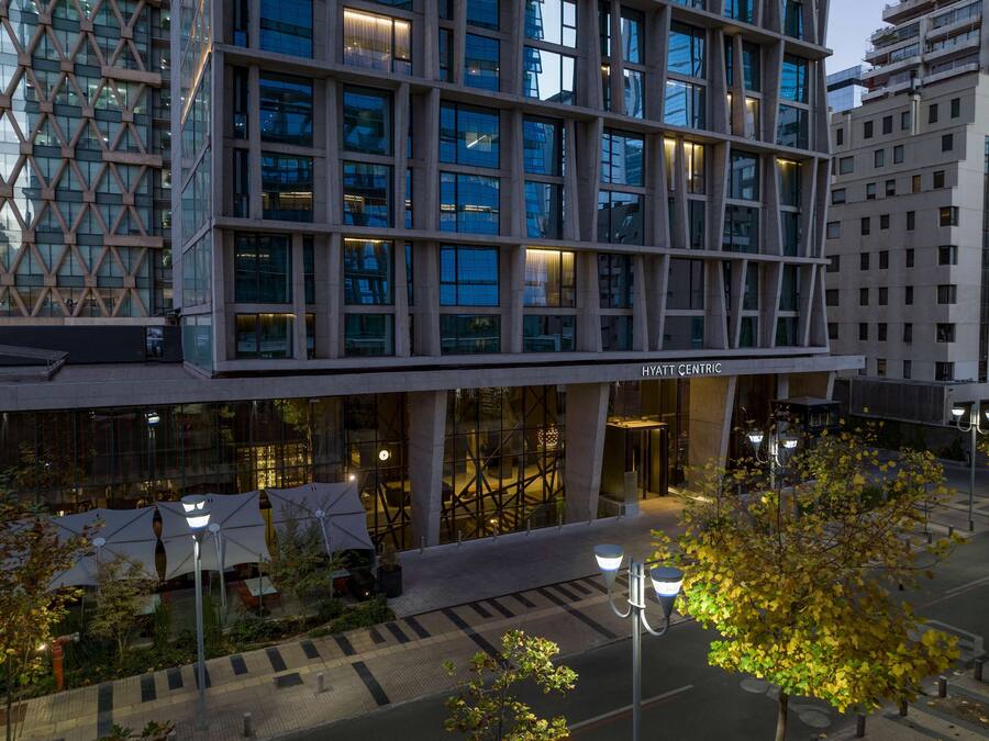 A modern building with a grid of windows and a sign reading "HYATT CENTRIC".