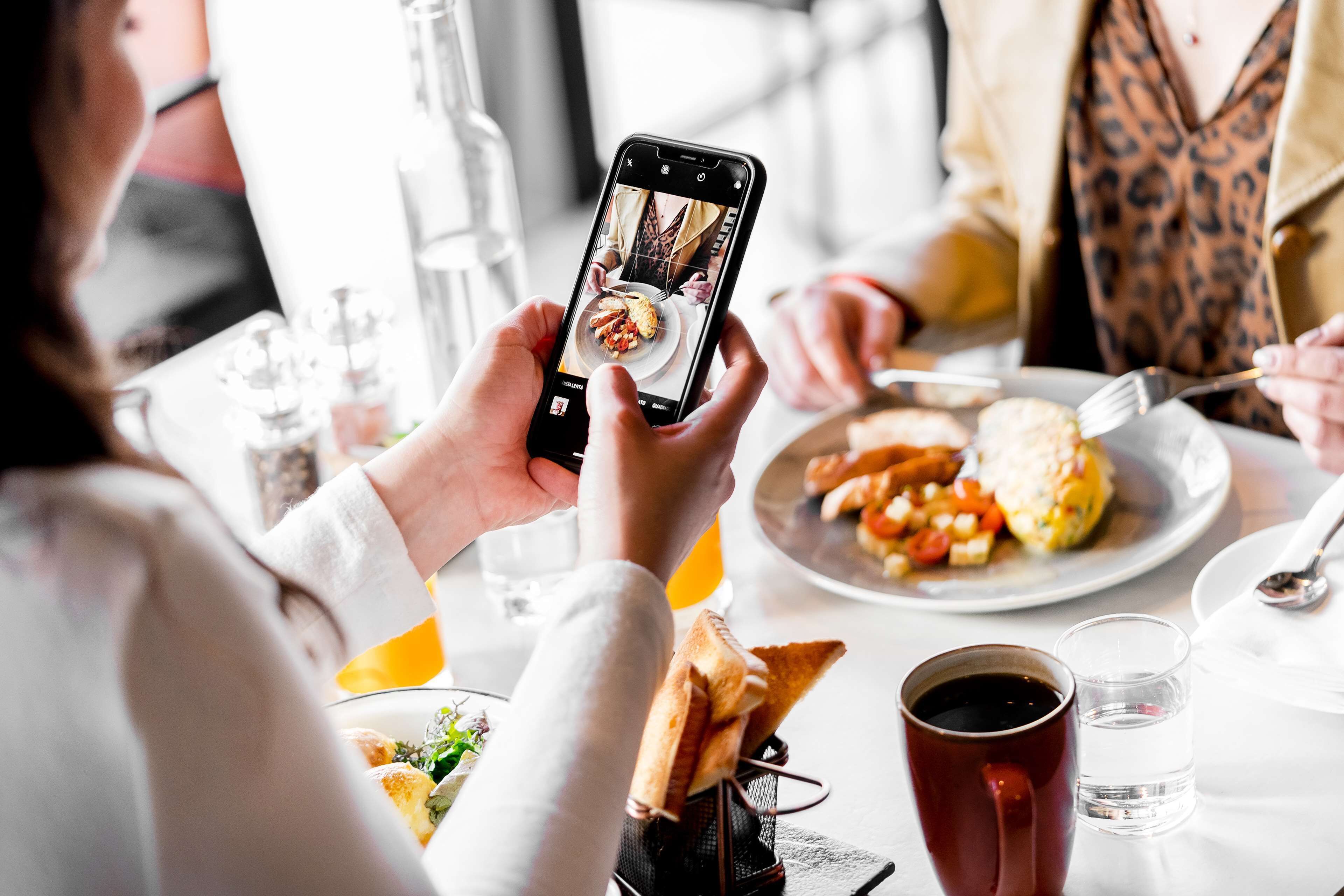 A person taking a photo of a meal with a smartphone.