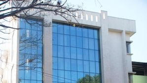En bygning med et skilt der viser 'Akshaya Lakshmi Comfort' og 'Business Hotel'.