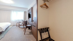 A hotel room with a bed, a desk, a TV, and a coat rack. - Richmond Hotel Naha Kumoji (Naha)