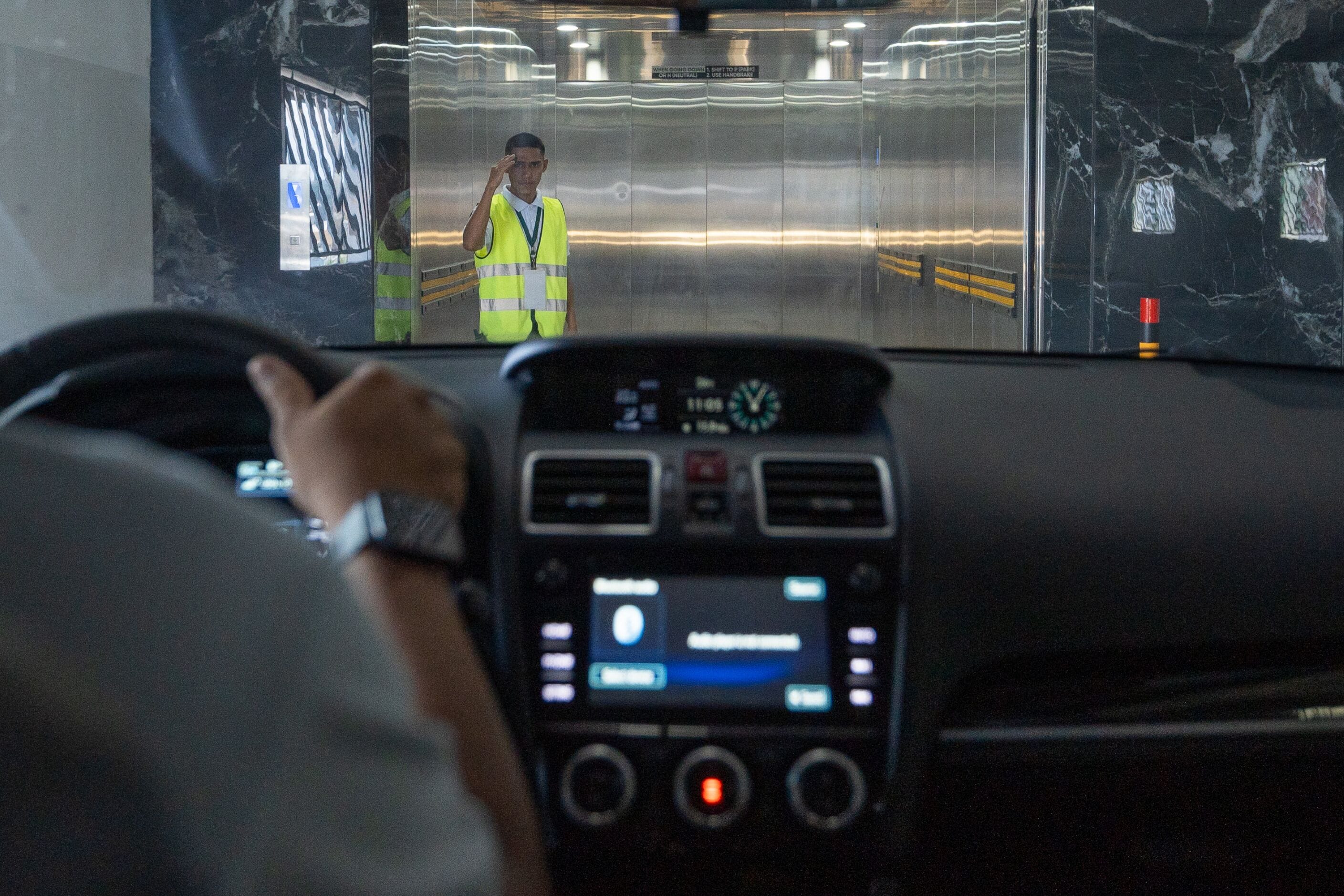 A vehicle interior with a dashboard displaying a clock and a radio.