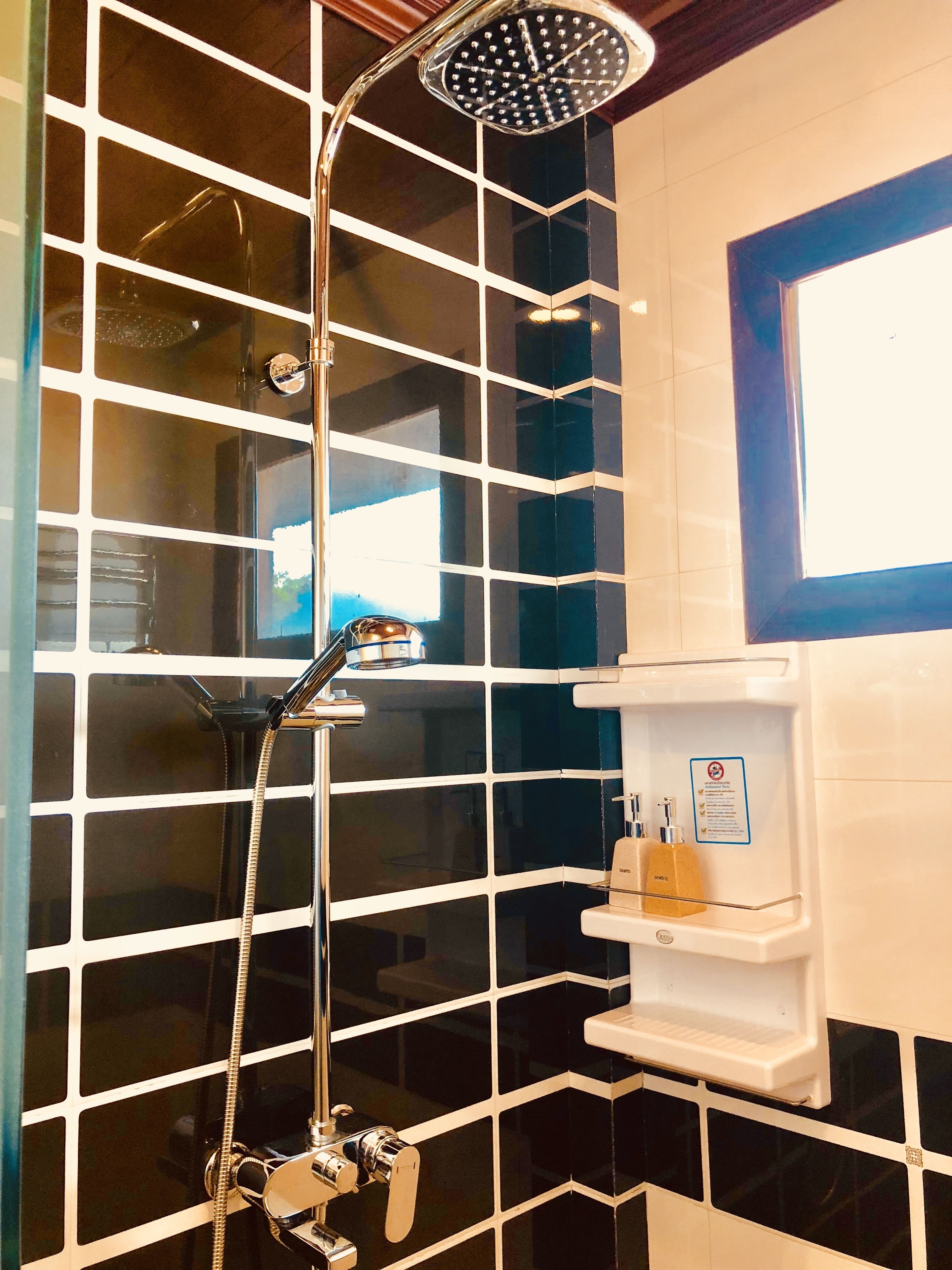 A bathroom with a shower, toilet, and sink.