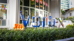A hotel entrance with a large 'Volarux' sign, glass windows, and a reflection of a person. - The VIEW at Vortex KLCC (Kuala Lumpur)