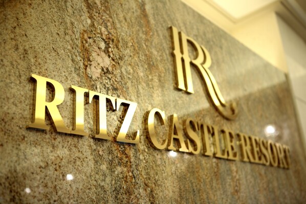 A close-up of a granite wall with the text "Ritz-Casals Resort" in gold lettering. - Ritz Castle Resort (Taean)