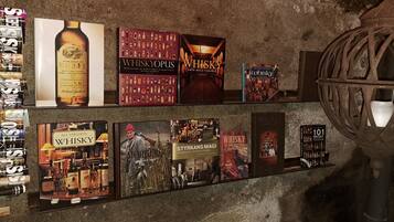 A wall with various whisky advertisements and bottles.