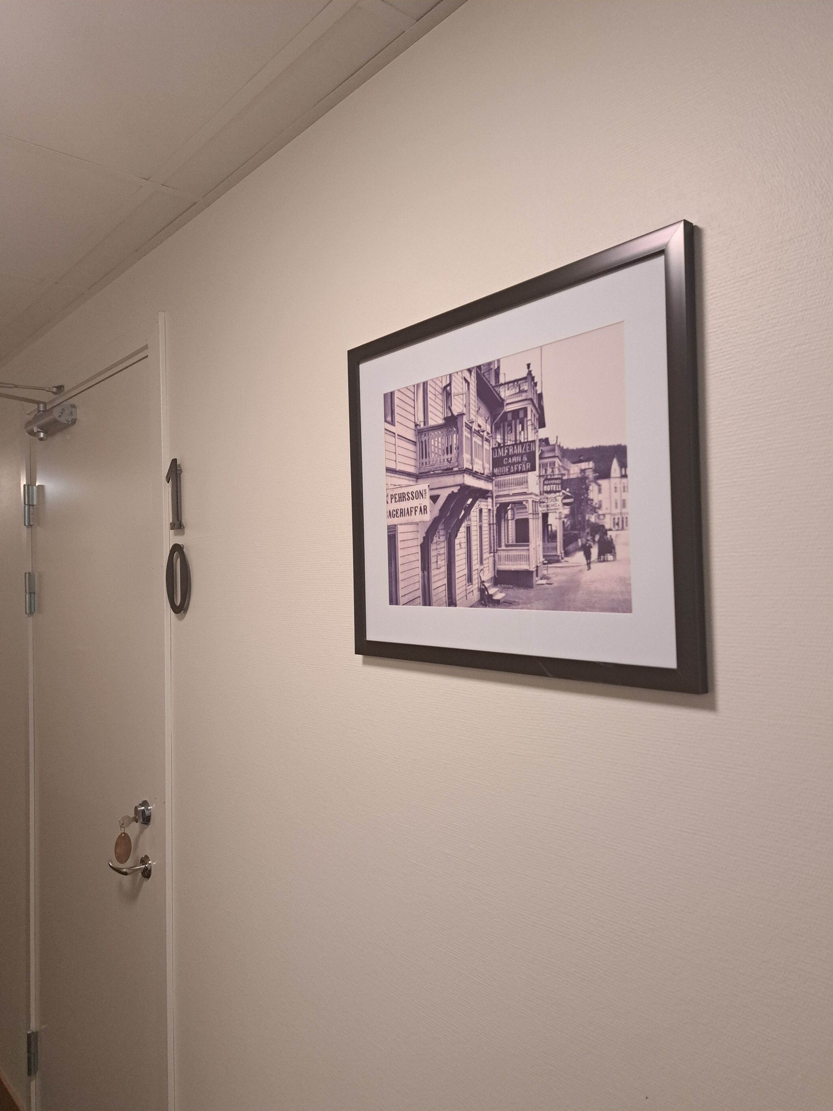Fotografía en blanco y negro, enmarcada, de un edificio histórico en una pared.