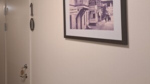 A framed black and white photograph of a historic building on a wall. - Kramfors Stadshotell (Kramfors)