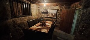 A rustic dining room with a wooden table, leather chairs, and a painting on the wall. - Kramfors Stadshotell (Kramfors)