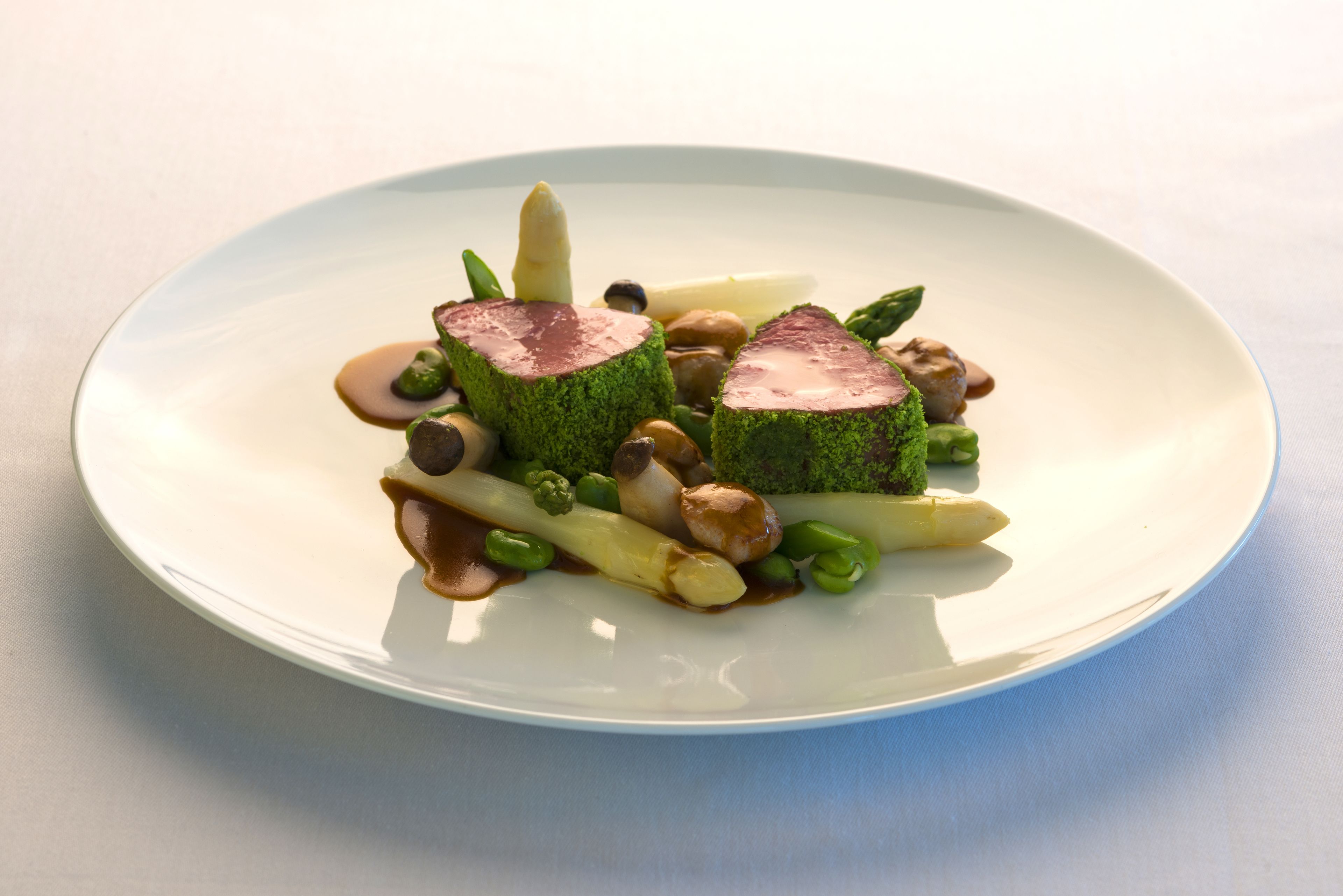 A plate of food with various vegetables and a piece of meat.