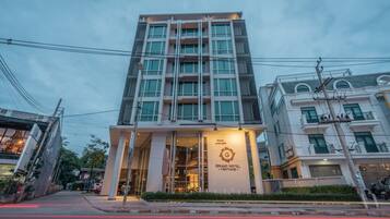A modern hotel building with a prominent entrance and a sign indicating it is the Grand Hotel.