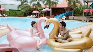 A swimming pool area with lounge chairs and umbrellas. - Pialo Resort (Na Klang)