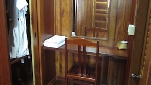 A wooden room with a wooden wardrobe, a chair, and a small table. - Pialo Resort (Na Klang)