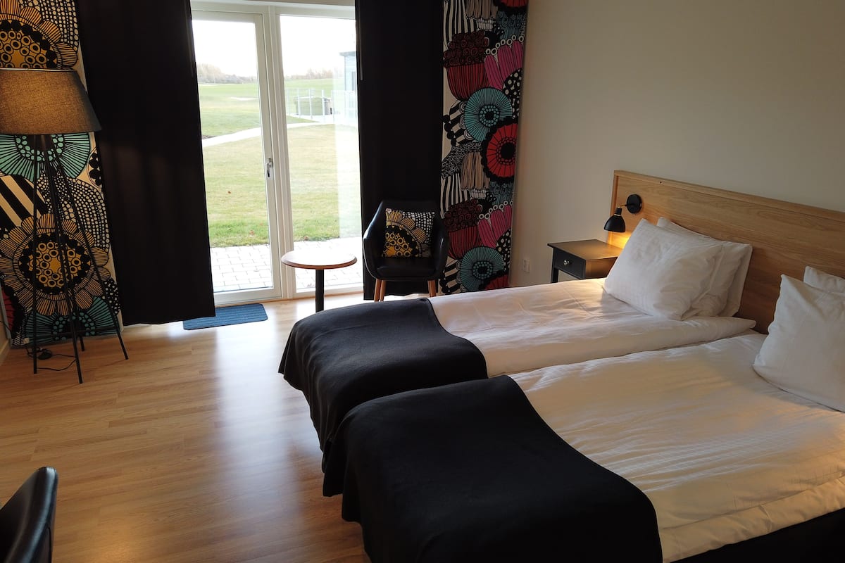 premium double room, 2 single beds, golf view | living area | led tv