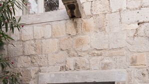 A stone-walled entrance with a door leading to an interior space. - Dubrovnik Sweet House (Dubrovnik)