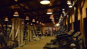A gym with treadmills, weight machines, and exercise equipment. - Ameg Lodge Kilimanjaro (Moshi)