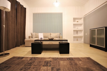 Business Suite, 1 Bedroom | Living area | 25-inch LED TV with cable channels, TV