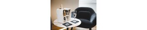 A table with a bottle of champagne, two glasses, and a black chair. - Mascherino Suites (Rome)