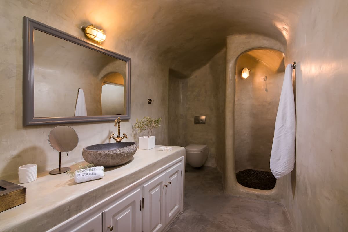 levanta cave suite with caldera view & hot tub | bathroom | shower, free toiletries, hair dryer, bathrobes