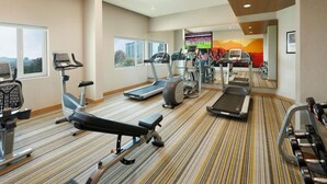 A gym with treadmills, elliptical machines, and weight equipment. - ibis Pune Hinjewadi Hotel (Paud)