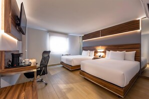 A hotel room with two beds, a desk with a coffee maker, a chair, and a TV mounted on the wall. - Sleep Inn Tijuana (Tijuana)
