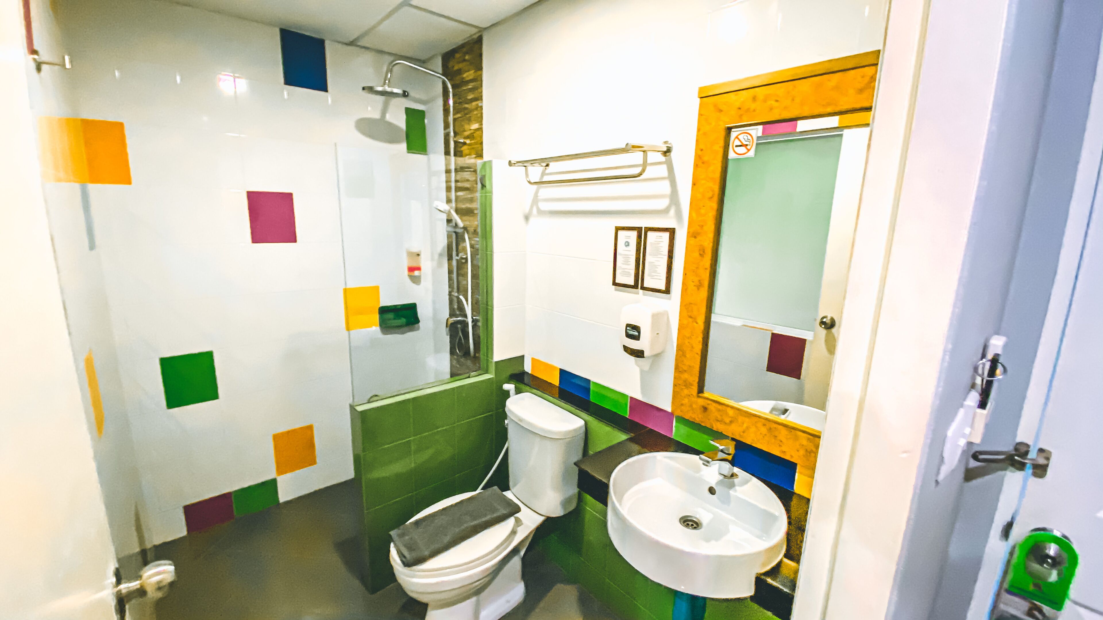 A bathroom with a toilet, sink, and shower.