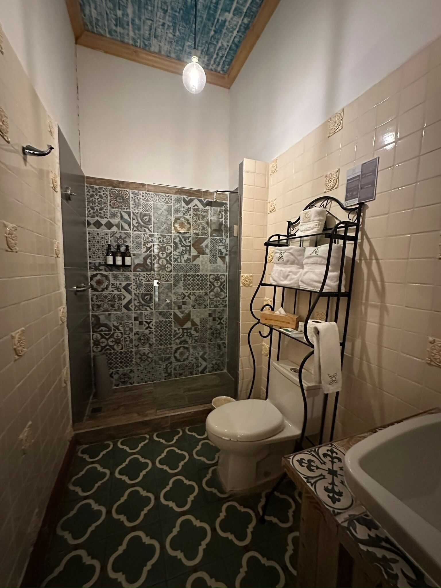 A bathroom with a shower, toilet, and bathtub.