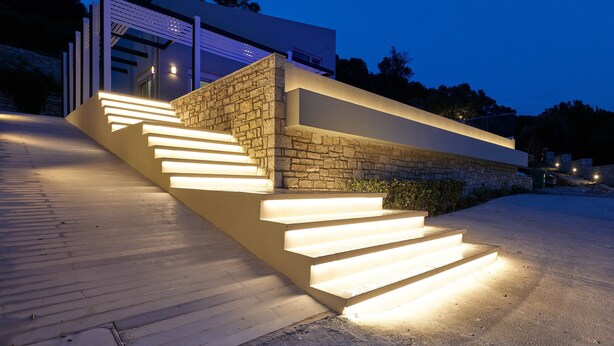 A modern building with a stone facade and a series of illuminated steps leading to a door. - Suitable For Families With Children, Groups Of Friends, Professionals, Friends (Rethimno)