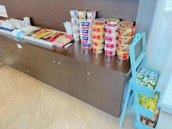 A buffet area with various food items and condiments.