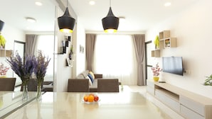 A modern living room with a glass dining table, two sofas, a TV, and pendant lights. - Ami Splendid Rooftop Pool (Ho Chi Minh City)