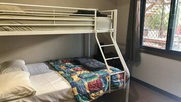A bunk bed room with a window and a view of the outside.