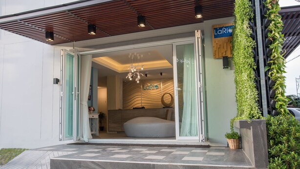 A modern hotel entrance with a large bathtub visible inside.